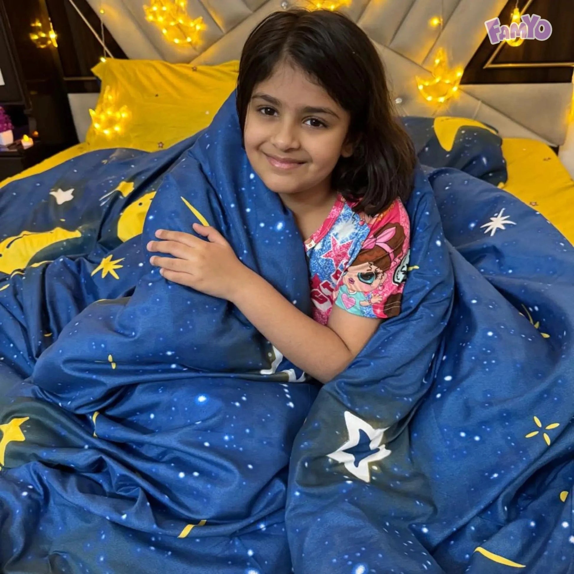 Child wrapped in the Famyo Moon and Stars comforter, enjoying its soft and cozy warmth
