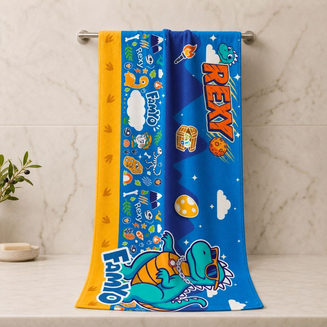 Rexy the Dino kids towel featuring soft quick-dry terry fabric, lightweight absorbent design, 70 × 140 cm size, and ideal for bath, beach, pool, swimming, travel, and everyday use.