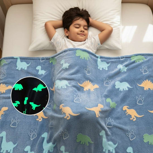 Child lying on a bed with a dinosaur-patterned blanket, including a close-up of glowing dinosaurs.