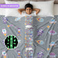 Child lying on a bed with a gray comforter featuring space-themed patterns, including a close-up of the glow-in-the-dark design.