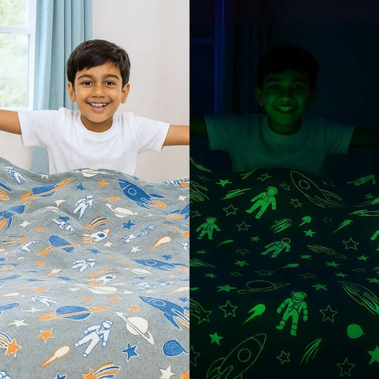 A child with space-themed bedding, shown under normal lighting and in its glowing-in-the-dark effect.

