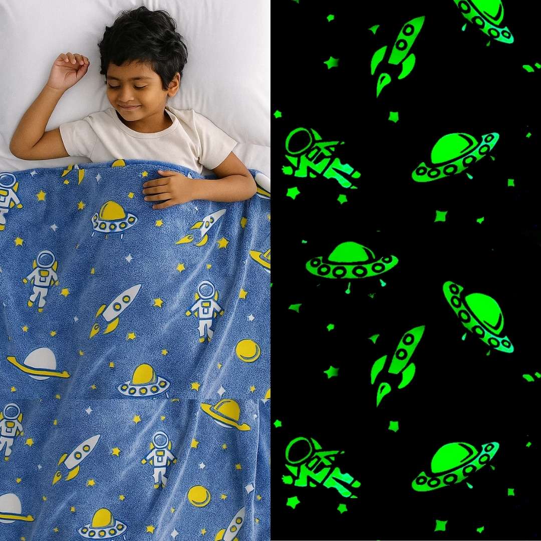 Child sleeping under a blue space-themed blanket with green glow-in-the-dark patterns.