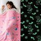 Pink mermaid-themed blanket with glow-in-the-dark design on a black background