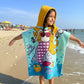 Child wearing Famyo Mermaid Princess poncho bath towel for kids, ages 1–7 years. Quick-drying microfiber hooded towel with magical mermaid princess design, ideal for bath, beach, or pool.