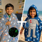 Two children wearing space-themed ponchos, one gray with space patterns and the other blue with an astronaut design.